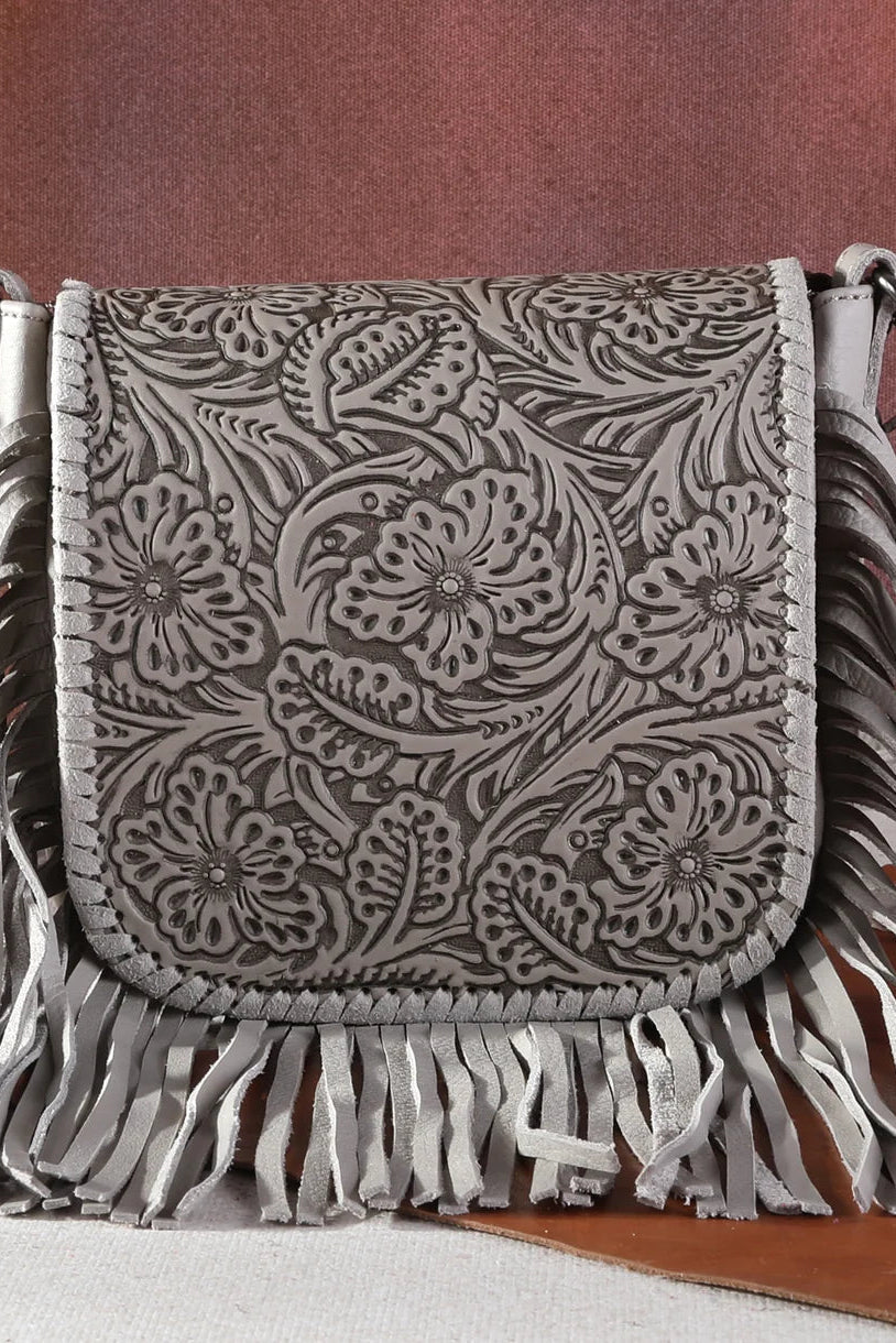 Trestles Clothing Company grey leather crossbody bag with intricate floral tooling, whipstitch trim, and long fringe.
